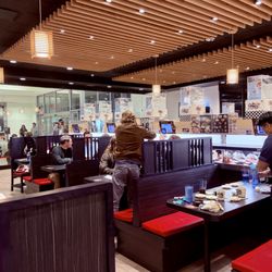Kura Revolving Sushi Bar - Dining area. Eat 15 plates and earn a little keychain prize from the dispensers