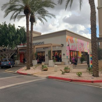 DR Miccolis - a storefront with palm trees - General Contractors Near Me