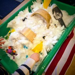 Children explore a winter-themed sensory bin while building fine-motor skills, curiosity and imaginative play.