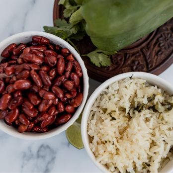 H kitchen - a bowl of rice, a bowl of red beans, and a bowl of green peppers - Honduran Near Me - Fort Worth, Texas