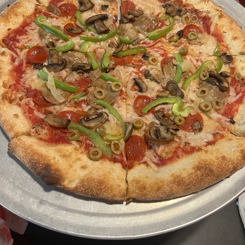 Valentino's Pizza - 14" Supreme Pizza with no black olives, one half-side of green olives, and the vegan cheese substitute. - Pizza Near Me - San Marcos, Texas