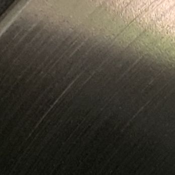 Napleton Auto Group - The image depicts a textured surface, likely a wall or floor, with visible lines and variations in shading. The photo is blurry and dark, making it difficult to identify specific details or context. - Car Dealers Near Me - Rosemont, Illinois