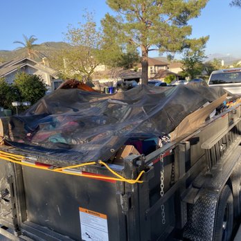 P. Crew Hauling - a truck with a tarp on the back - Junk Removal & Hauling Near Me P. Crew Hauling - a truck with a tarp on the back - Junk Removal & Hauling Near Me