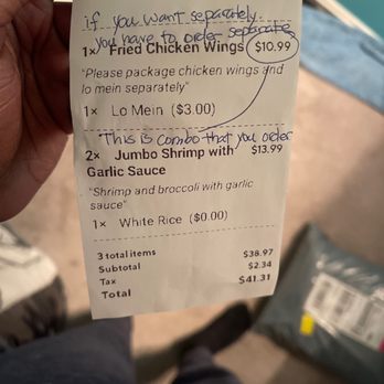 China Wok - a person holding a receipt - Chinese Near Me - Owings Mills, Maryland