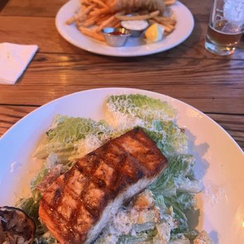 Mission Rock Resort - Salmon Caesar salad (in front) & fish & chips (in back) - Seafood Near Me - San Francisco, California Mission Rock Resort - Salmon Caesar salad (in front) & fish & chips (in back) - Seafood Near Me - San Francisco, California