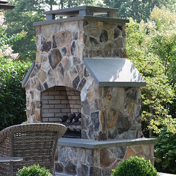 Green Landscape - a stone outdoor fireplace in the middle of a garden - Landscaping Near Me Green Landscape - a stone outdoor fireplace in the middle of a garden - Landscaping Near Me