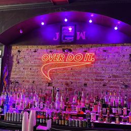 a bar with a neon sign a bar with a neon sign