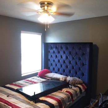 Crdr Services - a bed in a bedroom with a blue tufted headboard - Home Cleaning Near Me