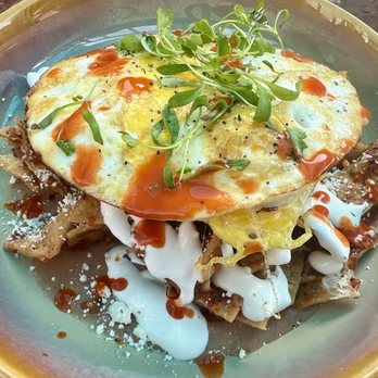 Eggy’s Neighborhood Kitchen - Chilaquiles Rojas over Peruvian beans with two fried eggs. - Breakfast & Brunch Near Me - Berkeley, California Eggy’s Neighborhood Kitchen - Chilaquiles Rojas over Peruvian beans with two fried eggs. - Breakfast & Brunch Near Me - Berkeley, California