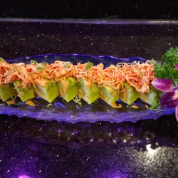 Neon Sushi - Sea dragon roll  Lobster  tempura  cucumber inside . Sliced avocado and kni salad on top. With Wasabi yuzu sauce and spicy mayo.