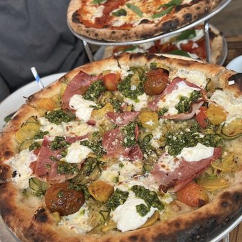 Roey's - Zucchini & Green Garlic Pesto (front) Soppressata Pizza (back) Burrata Pizza (under) - Pizza Near Me - New York, New York Roey's - Zucchini & Green Garlic Pesto (front) Soppressata Pizza (back) Burrata Pizza (under) - Pizza Near Me - New York, New York