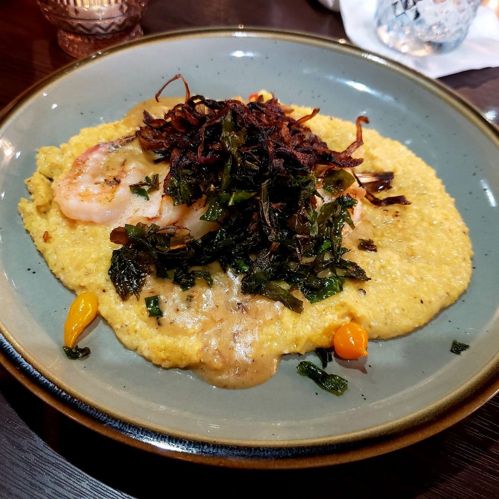 Kounter - Shrimp & Grits - Bourbon butter grilled shrimp, fried collards, white cheedar grits tasso ham gravy & crispy shallots - New American Near Me - Rock Hill, South Carolina