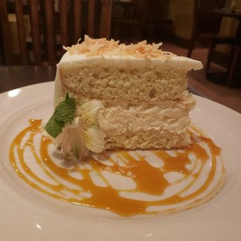 Wild Sage Bistro - Coconut cake with lilikoi sauce. - New American Near Me - Spokane, Washington Wild Sage Bistro - Coconut cake with lilikoi sauce. - New American Near Me - Spokane, Washington