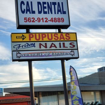 Pupuseria Brisas de Acajutla - a sign for a dental clinic - Salvadoran Near Me - Long Beach, California