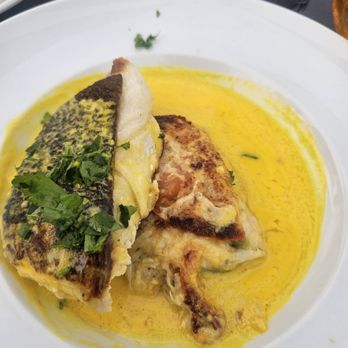 Coast Guard House - Halibut - yellow sauce did not look appetizing but it tasted good. Under the fish was potato with cheese. - Seafood Near Me - Narragansett, Rhode Island
