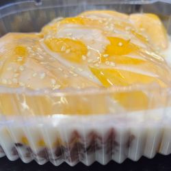 Homemade Mango Sticky Rice includes fresh mango, warm purple sticky rice, coconut drizzle with sesame seeds on top!