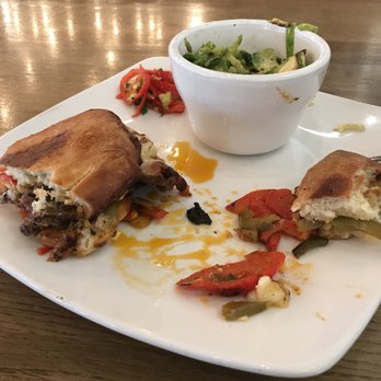 Big Grove Tavern - Cheesesteak sandwich with Brussels sprouts.  Notice oil slick on plate and pile of peppers to the left of Brussels sprouts. - New American Near Me - Champaign, Illinois