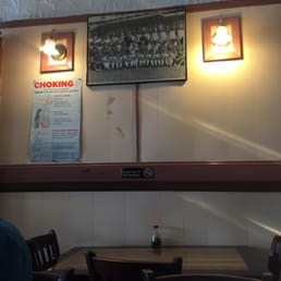 A picture of the wall where a Peruvian soccer team picture and a poster about first aid both hang.