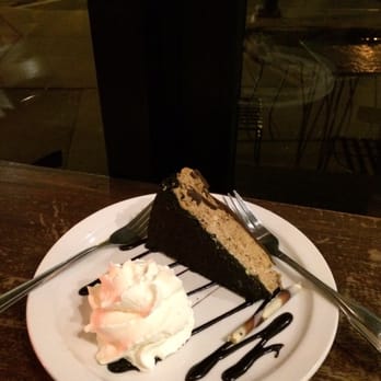 Caffe Aroma - Cappuccino cheesecake topped with whipped cream and chocolate drizzle - Cafes Near Me - Buffalo, New York