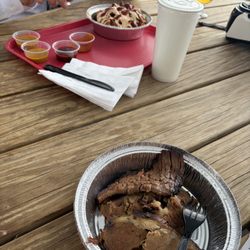 In the background is the baked potato with sausage. He loved his meal.