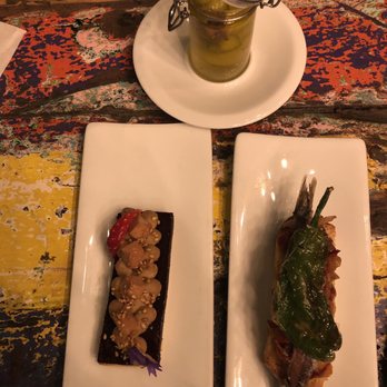 Xarma - An anchovy, pepper, onion and tapenade pinxto and our desert pb&j pinxto with a cherry gelatin and peanut butter over a cracker - Basque Near Me - Donostia / San Sebastián, SS