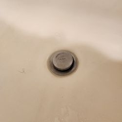 The Lodge - Hair in tub, hair band on floor, looking for an outlet I moved the bedside table, and ugh...I don't want to know what this is on the wall.