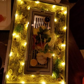 Barton G - The crab salad plate. The crabs are on the bottom sides covered with glass on top of them - New American Near Me - Miami Beach, Florida