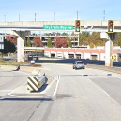 Hertz Rent A Car - Cross this intersection and go to the "Car Returns" side. You'll see a sign on the left saying "Customer Parking"