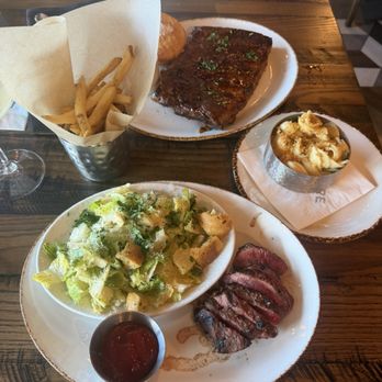 Haywire - Cowgirl dinner: steak, Caesar salad, tallow fries, and comes with a martini (or another eligible drink) BBQ baby back ribs with Mac n cheese - New American Near Me - Austin, Texas