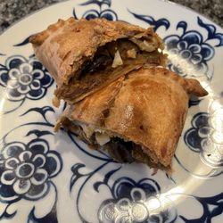 Empanadas Maria Elba - Steak empanada cut in half to see the filling.
