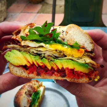 Gjusta - Breakfast sandwich on fresh baked onion Bialy with egg, Gruyere, arugula, Harissa, porchetta and avocado.  Incredible. - Bakeries Near Me - Venice, California