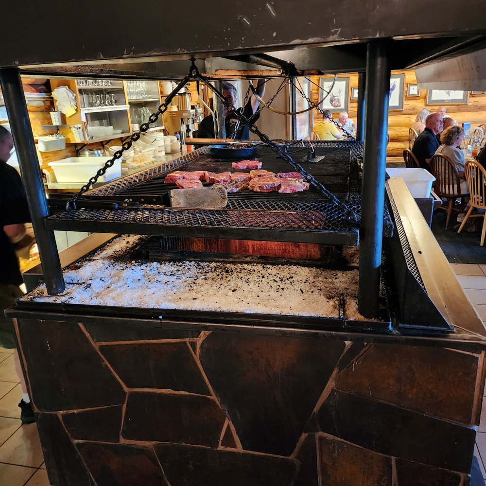 a grill with steaks on it a grill with steaks on it