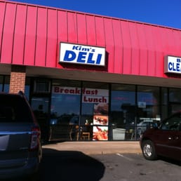 two cars parked in front of the deli