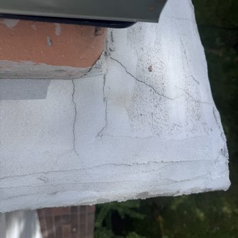 Shamrock Chimney - Cracks in the newly fixed crown. This should have had sealant applied to it in accordance with industry standards - Chimney Sweeps Near Me