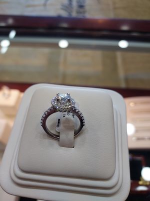 Diamond Halo Ring - The diamond halo ring boasts timeless elegance with a 1.00-carat FG lab-grown diamond as its centerpiece. The lab-grown diamond reflects a commitment to ethical and sustainable practices, offering a dazzling focal point with its colorless to near-colorless grading. Encircled by a halo of smaller diamonds, this ring enhances the overall brilliance and aesthetic appeal. Set in a carefully crafted mounting, the choice of metal further complements the design, whether it be white gold, yellow gold, rose gold, or platinum. The result is a sophisticated piece of jewelry that combines modern sensibilities with classic charm, making it a captivating symbol of love and commitment while prioritizing ethical considerations in its creation. Diamond Halo Ring - The diamond halo ring boasts timeless elegance with a 1.00-carat FG lab-grown diamond as its centerpiece. The lab-grown diamond reflects a commitment to ethical and sustainable practices, offering a dazzling focal point with its colorless to near-colorless grading. Encircled by a halo of smaller diamonds, this ring enhances the overall brilliance and aesthetic appeal. Set in a carefully crafted mounting, the choice of metal further complements the design, whether it be white gold, yellow gold, rose gold, or platinum. The result is a sophisticated piece of jewelry that combines modern sensibilities with classic charm, making it a captivating symbol of love and commitment while prioritizing ethical considerations in its creation.