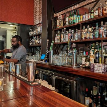 Theory - a bartender pouring a drink at a bar - Wine Bars Near Me - Oakland, California Theory - a bartender pouring a drink at a bar - Wine Bars Near Me - Oakland, California