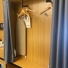 Closet with hangers and ironing board and iron Closet with hangers and ironing board and iron