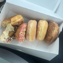 Maple bacon, chocolate sprinkles, strawberry cake with nuts, sugar, glazed, and cinnamon crunch