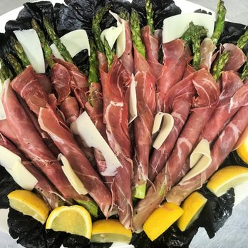 Pagano's Catering - Fresh, grilled asparagus rolled in prosciutto with shaved asiago cheese in light lemon vinaigrette - Caterers Near Me Pagano's Catering - Fresh, grilled asparagus rolled in prosciutto with shaved asiago cheese in light lemon vinaigrette - Caterers Near Me