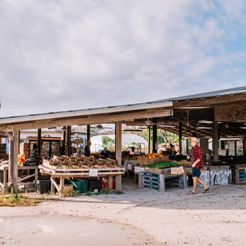 Jessicas Organic Farm - An external view of Jessica's Organic Farm, early in the morning before opening, showing a customer, fresh fruit and sprouts. - Organic Stores Near Me - Sarasota, Florida Jessicas Organic Farm - An external view of Jessica's Organic Farm, early in the morning before opening, showing a customer, fresh fruit and sprouts. - Organic Stores Near Me - Sarasota, Florida