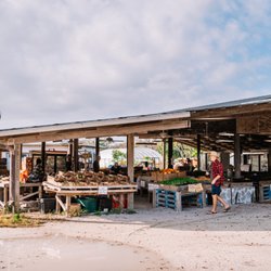 Jessicas Organic Farm - An external view of Jessica's Organic Farm, early in the morning before opening, showing a customer, fresh fruit and sprouts.