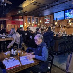 East Village Grille - Inside in the room with the bar and media. Packed.