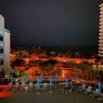 Tru by Hilton Pompano Beach Pier - Evening view looking over pool out to pier from room balcony - Hotels Near Me - Pompano Beach, Florida