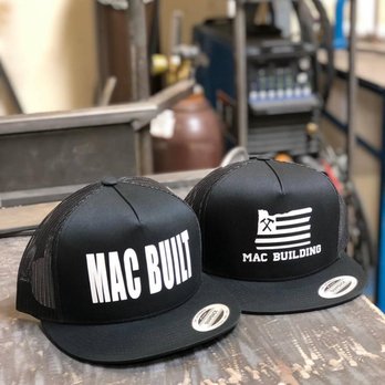 Mac Building - two hats on a table - Metal Fabricators Near Me Mac Building - two hats on a table - Metal Fabricators Near Me