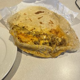 Chorizo burrito, I pulled apart to add sour cream and guacamole. Chorizo burrito, I pulled apart to add sour cream and guacamole.