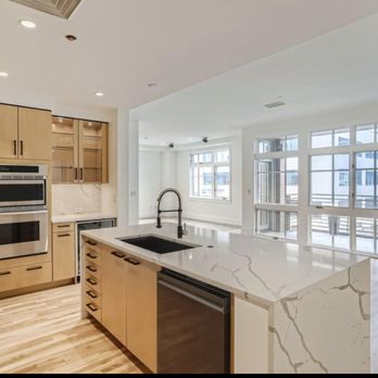 Redux Remodeling - a kitchen with marble countertops - General Contractors Near Me