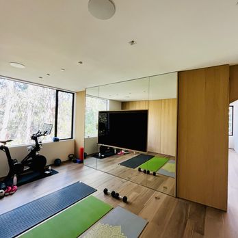Leon Audio Video - In home gym with Paradigm speakers and Samsung Tv mounted within mirrored space . - Home Theatre Installation Near Me - Half Moon Bay, California Leon Audio Video - In home gym with Paradigm speakers and Samsung Tv mounted within mirrored space . - Home Theatre Installation Near Me - Half Moon Bay, California