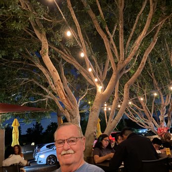 Postino Central - Love the tree on the patio (and my handsome hubby, too). - Wine Bars Near Me - Phoenix, Arizona