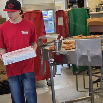 Krispy Kreme - One staff member takes a box of doughnuts to a customer. - Coffee & Tea Near Me - Roanoke, Virginia