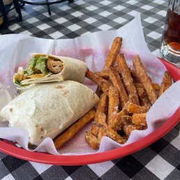 Buffalo wrap and sweet potato fries.  Tea in a frosted mug.